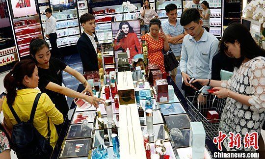 资料图 游客在三亚国际免税城购买免税商品。中新社记者 尹海明 摄 