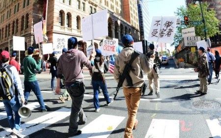 大费城华人枪友会成员带着长短枪在费城华埠及市中心游行，举着“不做受害者”、“停止犯罪”等标语。(美国《侨报》/罗晓媛 摄)